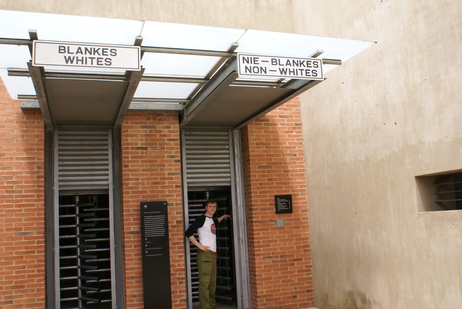Segregated entrance gates at the Apartheid Museum, Johannesburg — one gate marked Whites, one marked Non-Whites