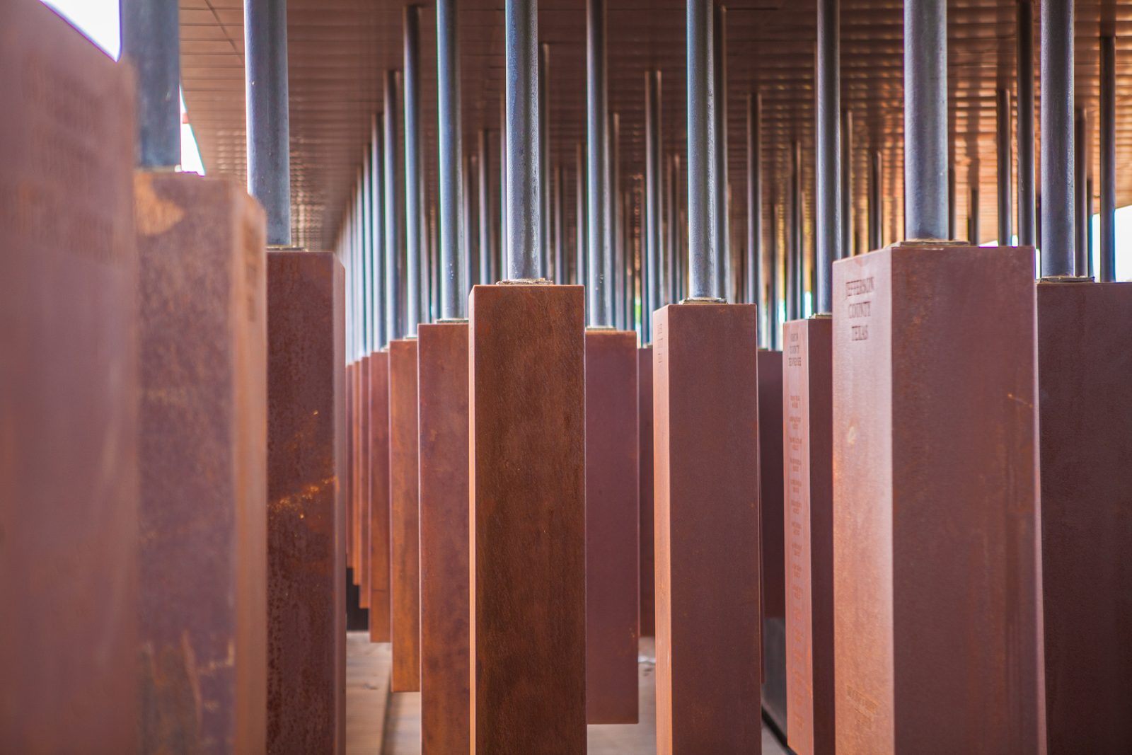 Rows of suspended steel monuments at the National Memorial for Peace and Justice, Montgomery, Alabama